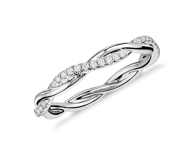 This beautiful and delicate wedding ring is formed by two intertwining bands, one of micropavé set diamonds and one of solid platinum for an elegant statement.