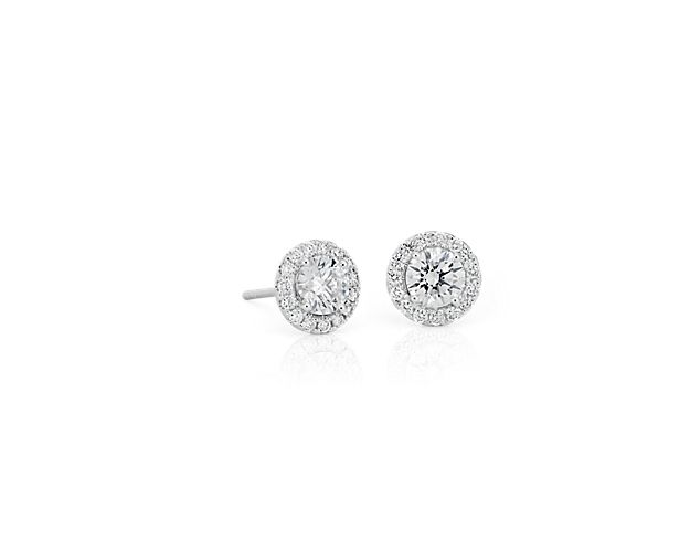 A style with incredible staying power, you can't go wrong with diamond halo stud earrings. Finely crafted in 14k white gold, each earring has a brilliant-cut 0.40 center diamond surrounded in a beautiful, sparkling halo. These are the perfect-sized earrings for everyday wear.