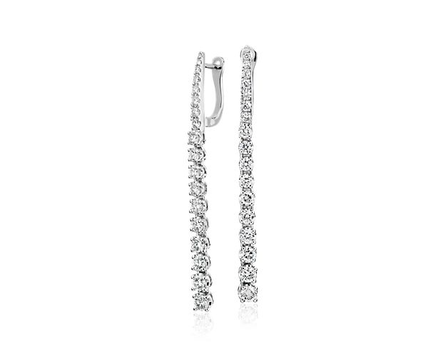 Light up any occasion with these dazzling 14k white gold earrings featuring a drop of 18 diamonds that dangle nearly two-inches, flirting with the shoulder.