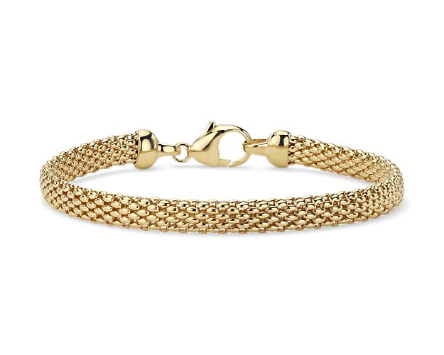 Flexible and bright with fascinating texture, this tightly woven 7.5” bracelet shines with the classic elegance of 14k yellow gold and secures with a lobster claw clasp.