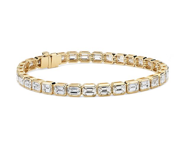 A timeless and exquisite addition to your jewelry box. This eternity bracelet showcases over night total carats of 33 expertly matched emerald-cut diamonds, bezel-set in enduring 18k Yellow Gold.