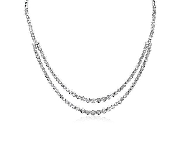 A single chain splits into two on the front of this diamond necklace that's set in crisp 14k white gold.