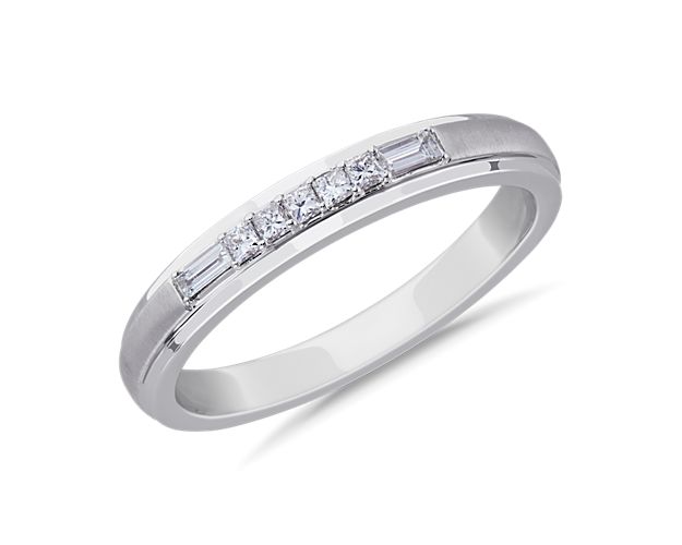 Princess cut diamonds are flanked by baguette diamonds, set in this platinum ring to provide a perfect balance of style and elegance.