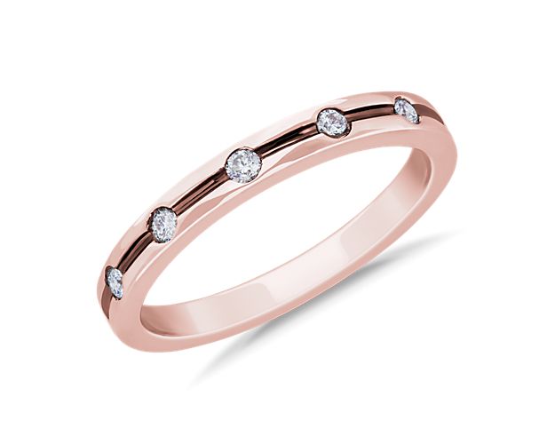 Capture the feeling of your romance with this diamond ring crafted from lustrous 14k rose gold. It features grooved detailing with evenly spaced diamonds set beautifully for a modern look.