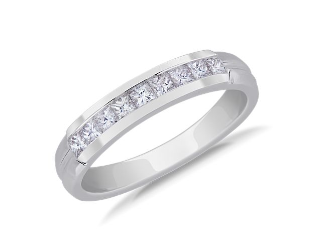 Keep your style sharp with this rich platinum wedding ring. A channel of princess-cut diamonds shines brilliantly between beveled edges.
