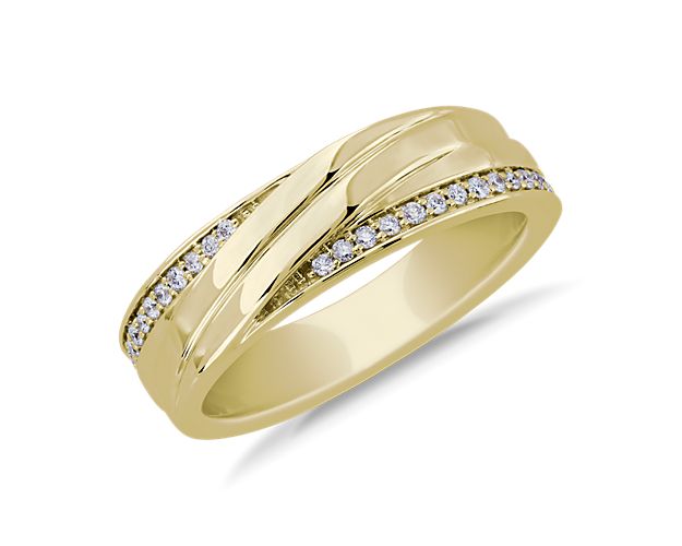 An elegant expression of your love is revealed through this 14k yellow gold band, set with diamonds sparkling on either edge of the swirl design.