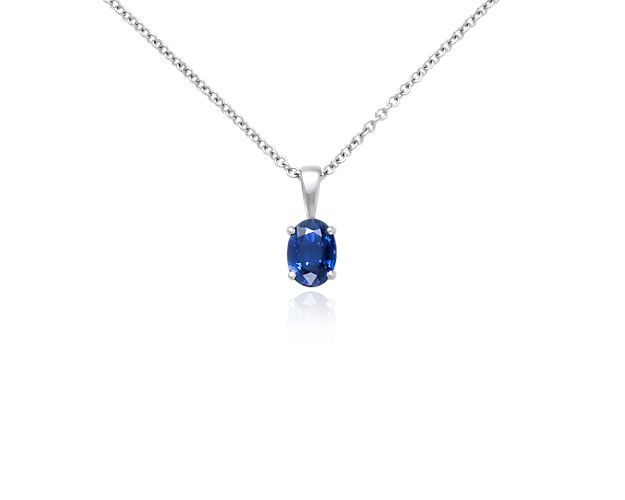 Our 18k white gold pendant holds a vibrant oval blue sapphire in a classic four prong setting. This pendant is suspended from an 18k white gold cable-link chain.