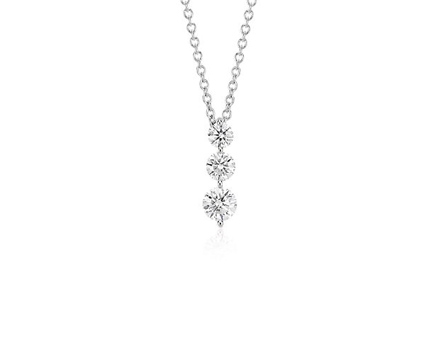 Symbolic of your past, present, and future, the three-stone diamond drop pendant showcases three round brilliant-cut diamonds in graduated sizes. Shared, 14k white gold prong settings allow for maximum brilliance. The three-stone diamond pendant hangs from a delicate 18-inch classic cable chain with a secure lobster claw clasp.