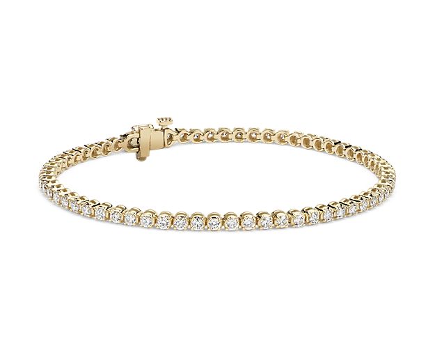 Simple and brilliant, this classic tennis bracelet features round, brilliant diamonds framed in 14k yellow gold.