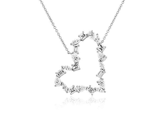 Add sparkle and love to your style with this heart-shaped pendant accented by beautifully sparkling diamonds in an eye-catching array of cuts. The 14k white gold design is delicately shaped and features a rich lustre.