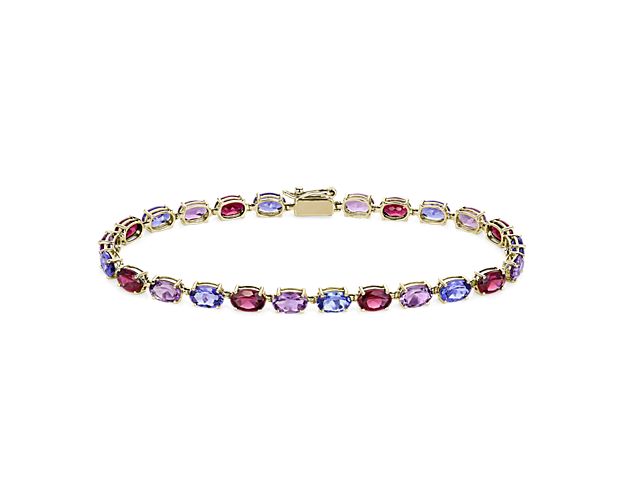 Bright tanzanite, amethyst and rhodalite stones shimmer brilliantly in this bracelet, summoning the eye to their rainbow of hues. The warmly lustrous 14k yellow gold design promises exquisite luxury that lasts.