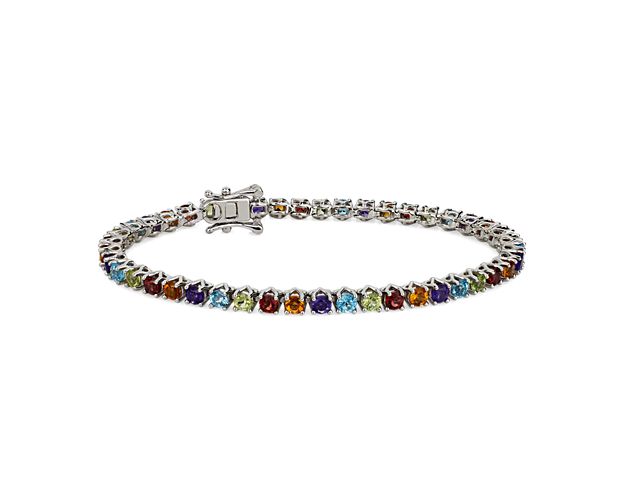 Let your wrist sparkle with a rainbow of hues when you wear this tennis bracelet featuring multi-colored stones that shimmer in the light. It is crafted from sterling silver and features a 3mm width.
