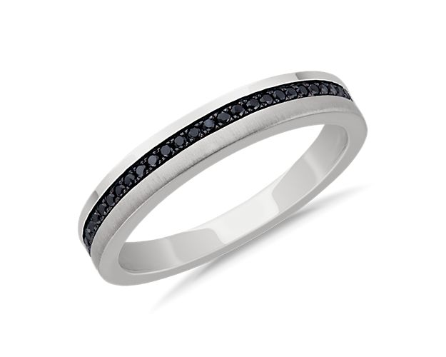 Subtle in brilliance, this wedding ring is crafted in enduring 14k white gold featuring a center band of round black diamonds.