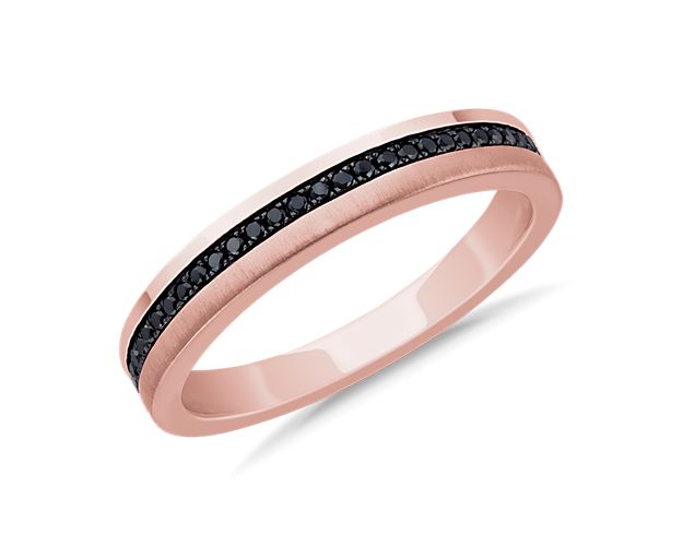 Subtle in brilliance, this wedding ring is crafted in enduring 14k rose gold featuring a center band of round black diamonds.