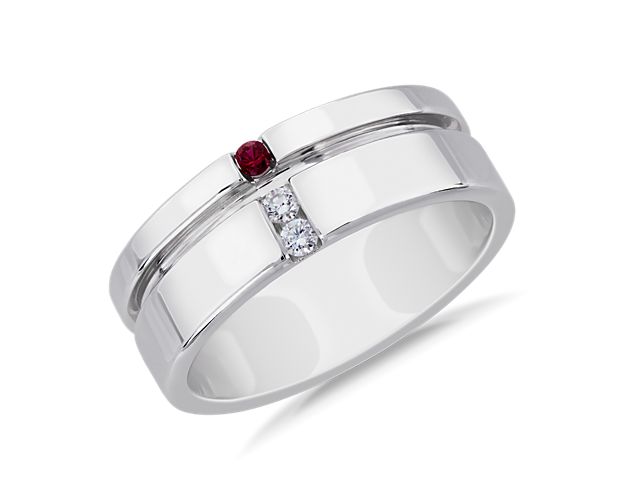 Two diamonds are vertically aligned with a single ruby on this platinum wedding band that has an off-center groove for a modern look.