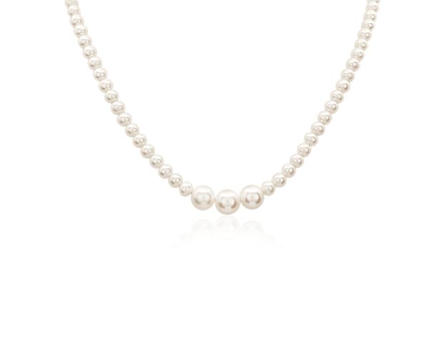 This beautiful freshwater pearl necklace features a strand of pearls with three larger pearls in the center.  Set with a 14k yellow gold clasp, this necklaces offers a spin on a classic pearl strand.