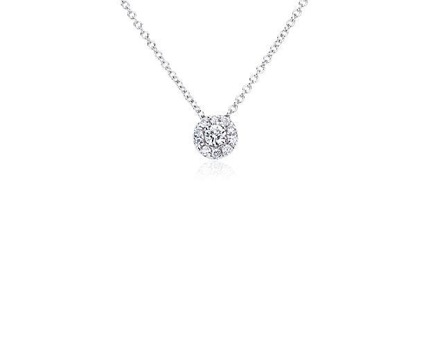 This diamond halo pendant shows the perfection of classic simplicity. A gorgeous round diamond offers a modern take on the style, complemented by a glittering halo of pavé diamonds all set in 14k white gold. This timeless diamond necklace works day-to-night and is sure to become a daily favorite.