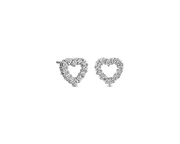 Catch the light when you wear these beautiful heart-shaped stud earrings set with delicate diamonds along the outline of the heart. The cool lustre of the 14k white gold design completes the look with enduring quality.