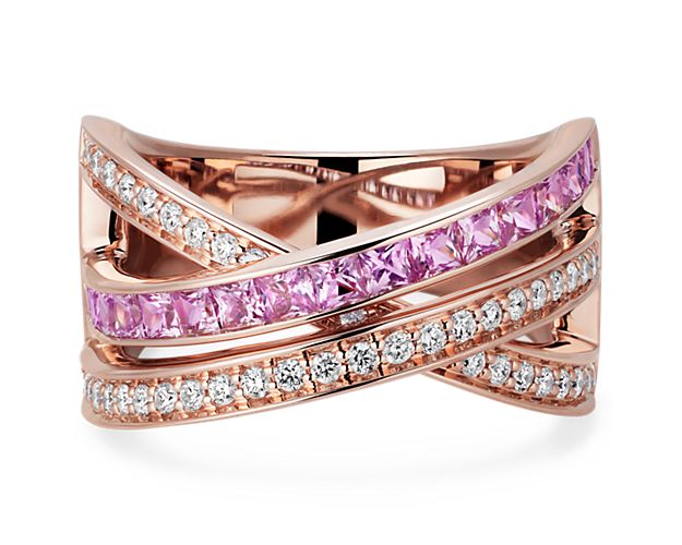 Add shimmer to your hand with this stunning ring featuring graceful cross-over design in gleaming 14k rose gold. It is set with brilliant diamonds and sparkling princess-cut pink sapphires that catch the light.