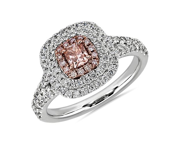 Enjoy the stunning glamour of this ring featuring a pink radiant-cut diamond surrounded by gorgeous halos of pink diamonds and white diamonds. The platinum and 18k rose gold design perfectly complements the stones and features white diamonds shimmering along the shanks for extra sparkle. This piece is accompanied by a GIA Certification. GIA Report Number: 7378623495