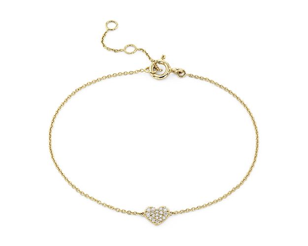 A petite heart, pave-set with tiny diamonds, is the focal point of this sweet bracelet crafted in gleaming 14k yellow gold.