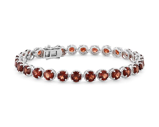 Brightly hued, this garnet bracelet is crafted in sterling silver and features twenty-eight round garnet gemstones in a flexible single line design.