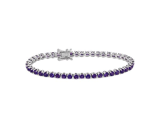 Brilliant purple amethysts shimmer as this timeless tennis bracelet catches the light. The 3mm-wide sterling silver design promises enduring quality and the cool gleam complements the stones.