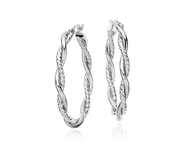A stylish addition to any look, these elongated oval hoop earrings are crafted in sterling silver tubing and offer a mix of high-polished and twisted textures.