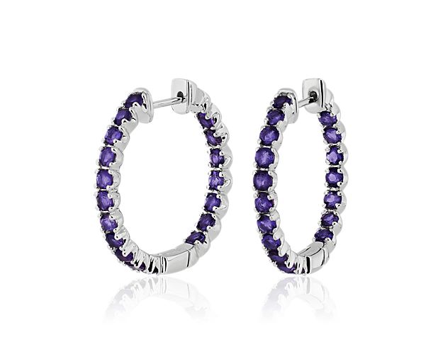 Look lovely in these gleaming hoops crafted from lustrous sterling silver. Each hoop features bright purple amethyst stones set along the front-facing edges.
