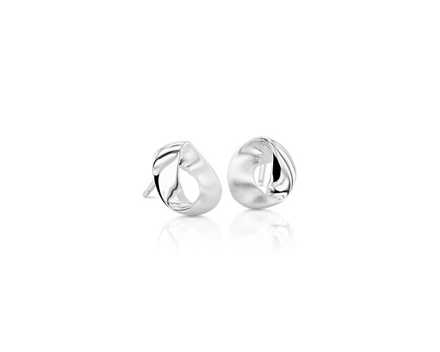 These playfully abstract unique earrings feature shimmering sterling silver loops that bend in beguiling shapes.