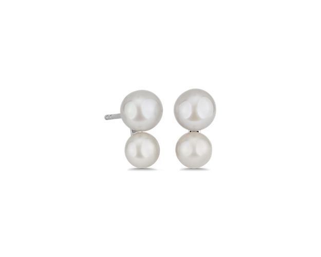 A cluster of two lustrous pearls gives these earrings a look of stately sophistication, set in sterling silver.