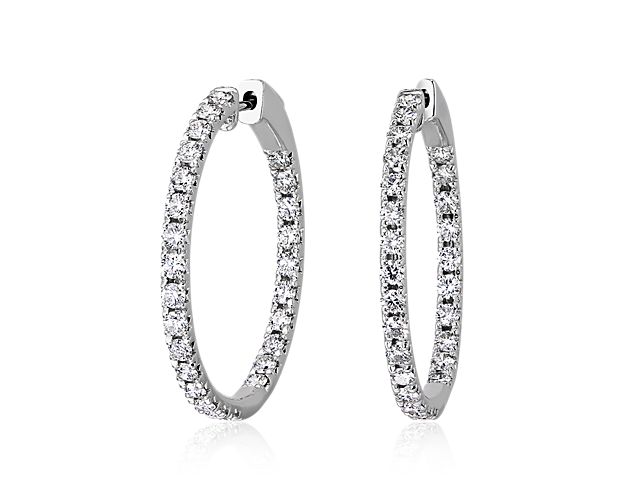 A celebration of light and minimalist design, French pave-set diamonds highlight these 14k white gold earrings hoop silhouette creating a subtle display of sparkle made for everyday wear. Diameter of hoop measures 1 1/8 Inches.