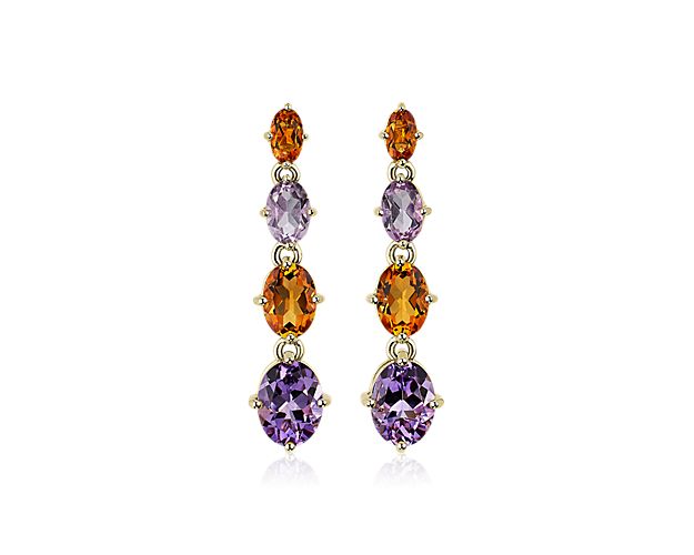 Catch the light as these stunning drop earrings sway, featuring vivid oval-cut citrine and amethyst stones alternating in beautiful symphony. They are intricately crafted from timelessly luxurious 14k yellow gold.