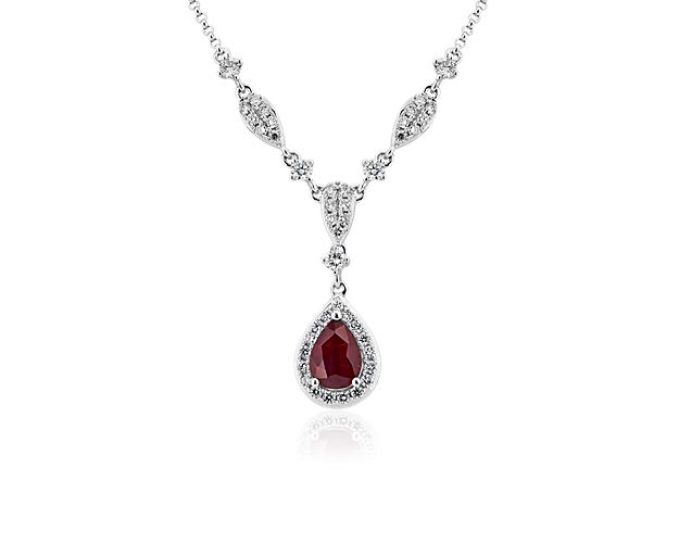 A colorful pear-shaped ruby dangles like a dewdrop from the center of this 14k white gold necklace, while diamonds outline its silhouette with their brilliant white light.