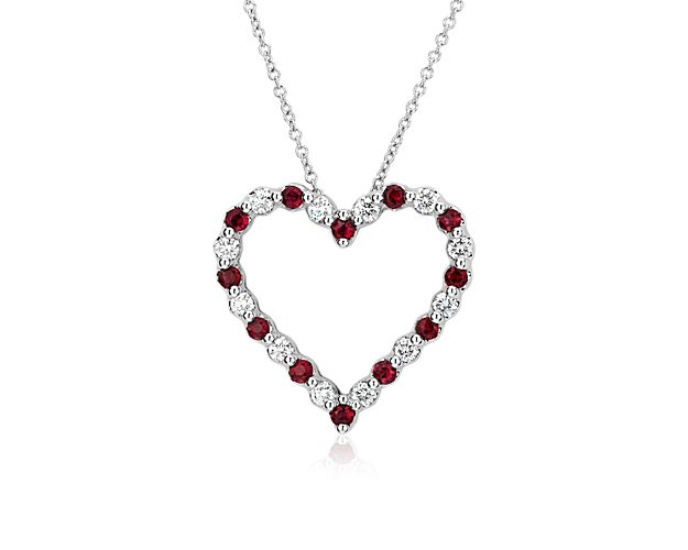 Elevate your look with the eye-catching romance of this floating pendant featuring a graceful heart shape crafted from lustrous 14k white gold. It is gorgeously set with bold red rubies that alternate with shimmering diamonds.