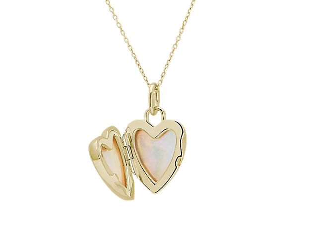 Heart locket in gold with mother of pearl siding.