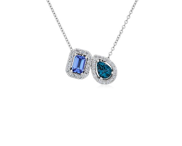 Elegantly eye-catching this two stone pendant necklace showcases an emerald-cut tanzanite stone in symphony with a pear-cut Blue Topaz. Diamond halos encircle both stones with sparkle, and the 14k white gold design promises lasting lustre.