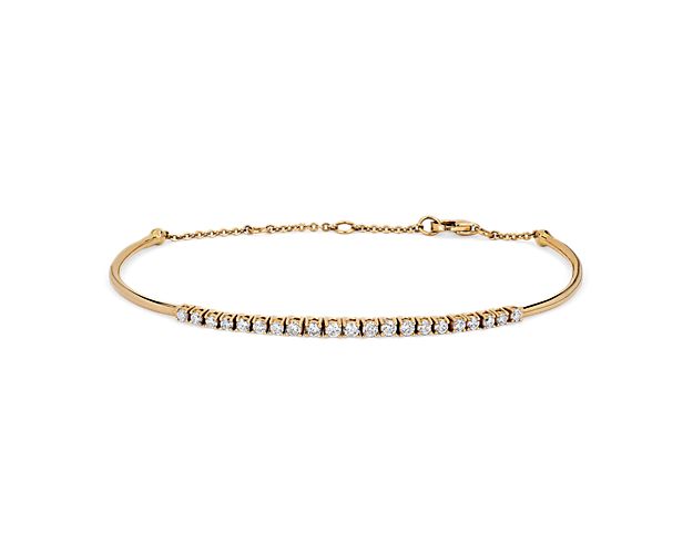 Lend luxurious shimmer to your wrist with this elegant bracelet featuring a row of diamonds sparkling along the front-facing edge. The bright gleam of the 14k yellow gold design beautifully complements the brilliant stones.
