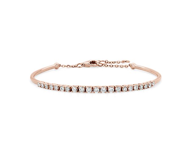 Elevate your look with luxurious sparkle with this simple and stunning bracelet featuring a delicate row of shimmering diamonds. It is designed in warmly lustrous 14k rose gold for enduring quality and beauty.