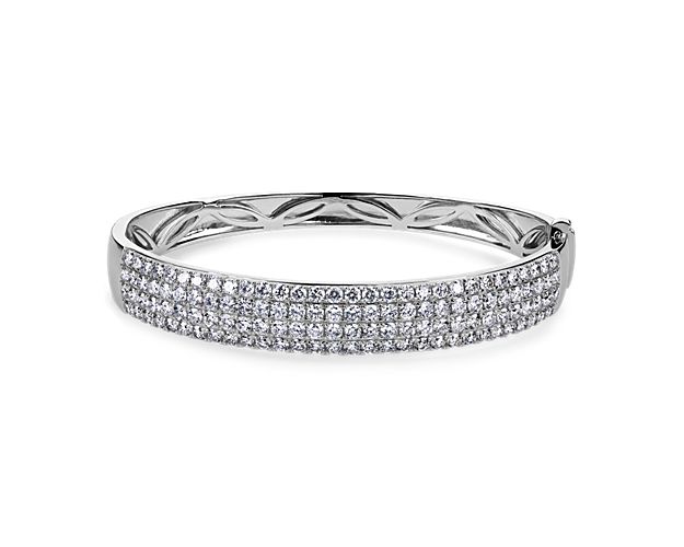 Take their breath away with this stunning shimmering bangle set with 5 ct. tw. of diamonds in multiple sparkling rows along the front edge. The cool lustre of the 14k white gold design beautifully complements the stones. Dimensions are 62mm x 52mm.