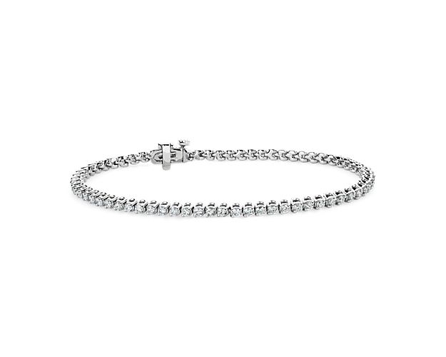 Timelessly luxurious and elegant, this classic tennis bracelet features 2 ct. tw. of diamonds shimmering along its length. The round-cut stones are beautifully held in two-prong settings in the lustrous 14k white gold design.