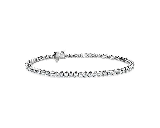 Beautifully elegant two-prong settings give this classic tennis bracelet a unique look that showcases the 3 ct. tw. in round-cut diamonds. It is crafted in luxuirously gleaming 14k white gold.