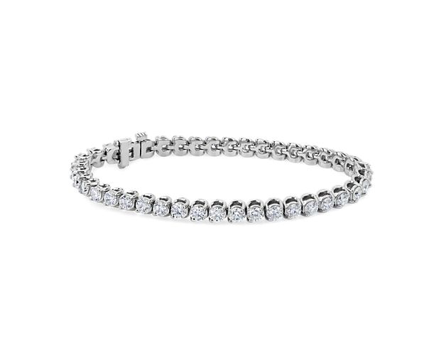 Embrace elegance with this stunning tennis bracelet designed in 14k white gold and featuring two-prong settings for a unique look. The 7 ct. tw. of round-cut diamonds shimmer brilliantly along its length.
