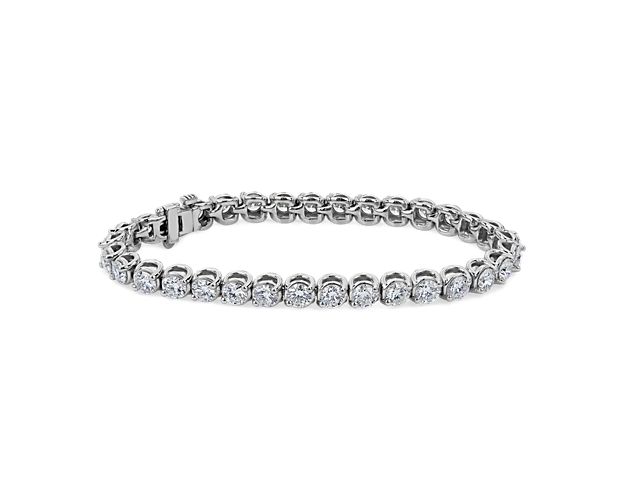 Sparkle in the light whenever you wear this gorgeous tennis bracelet set with 10 ct. tw. in round-cut diamonds. The lustrous 14k white gold design features unique two-prong settings to show off the stones.