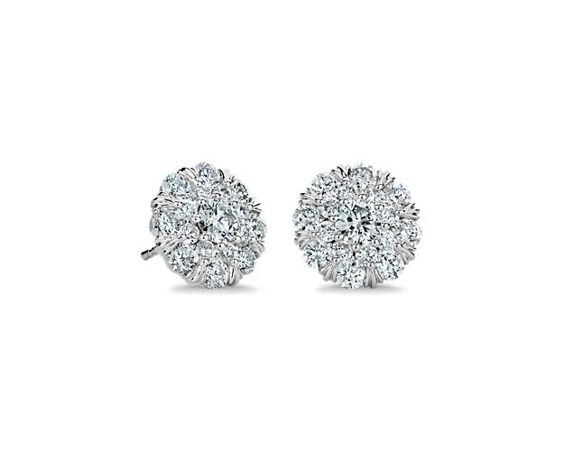 Introduce elegant sparkle to your look when you wear these classic stud earrings defined by a round centre diamond nestled in a double halo of diamonds for a dramatic effect. The 14k white gold setting complements the stones with a luxurious gleam.