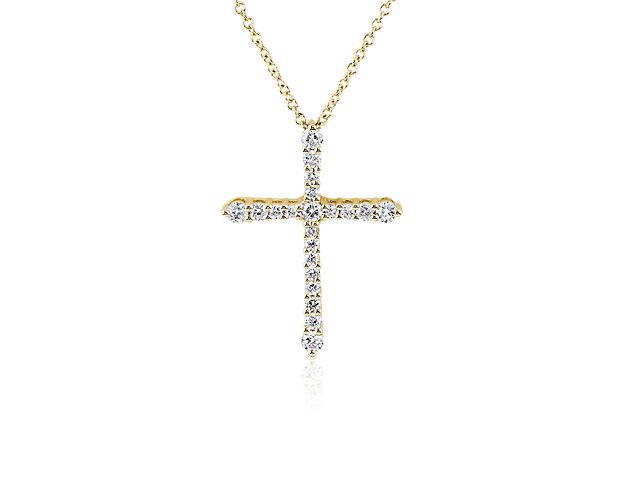 Let your faith shine when you wear this stunning tapered cross pendant set with stunning diamonds for breathtaking sparkle. The brilliance of the stones is beautifully matched with the gleam of the 14k yellow gold design.