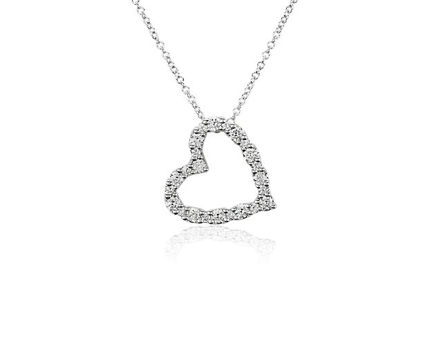 This whimsical heart-shaped pendant hangs gracefully at a tilted angle. The gleaming 14k white gold design is beautifully set with brilliantly shimmering diamonds for a mesmerizing look.