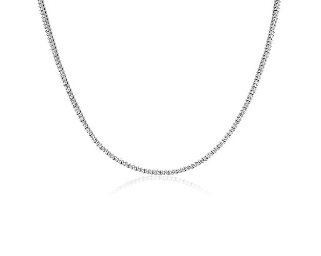 Embrace dramatic sparkle with this gorgeous eternity necklace featuring lustrous 14k white gold design with elegant two-prong settings. Round-cut diamonds run along its length, shimmering brilliantly in the light.