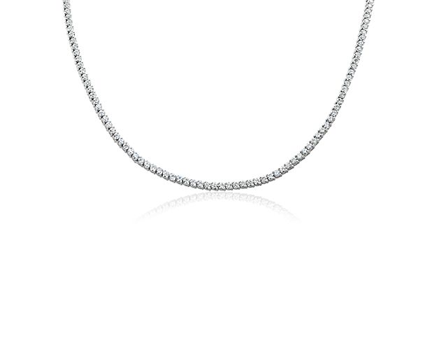 This shimmering eternity necklace is defined by stunning round-cut diamonds sparkling endlessly along its length. It is designed in lustrous 14k white gold, with two-prong settings highlighting the stones in elegant style.