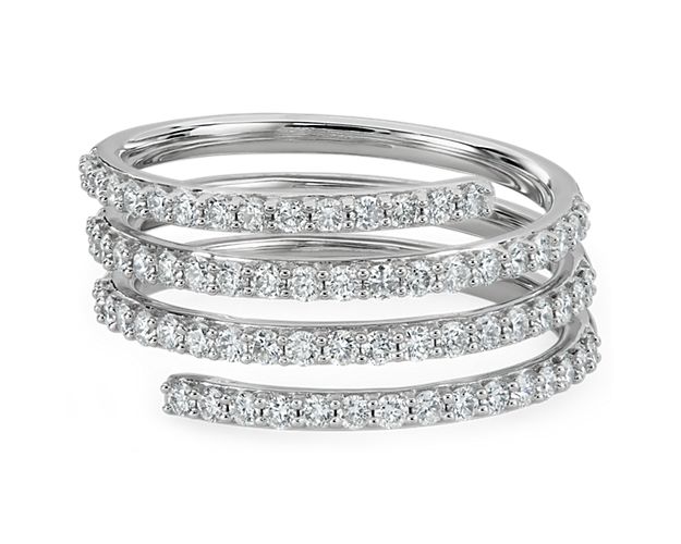 This beautifully unique ring features an elegant coiled design, with shimmering diamonds sparkling brilliantly along the front-facing edges of the spiral. It is designed in 14k white gold, and promises enduring luxurious quality.